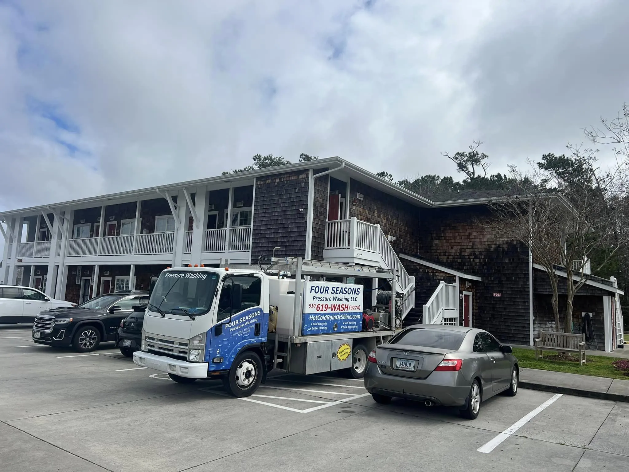 power-washing-truck-on-location-at-residential-driveway-by-swimming-pool-wilmington-nc